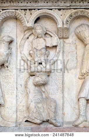 MODENA, ITALY - JUNE 04: Plate with stories from Genesis: Story about Abel and Cain, God the Father, relief by Wiligelmo, Modena Cathedral, Italy on June 04, 2017.