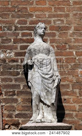 VERONA, ITALY - MAY 27: Female statue on the portal of Saint Eufemia Gothic-style, Roman Catholic church in Verona, Italy, on May 27, 2017.