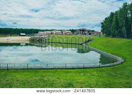 Green Public Park With Pond Meadow Grass Field Blue Sky For Leisure Landscape