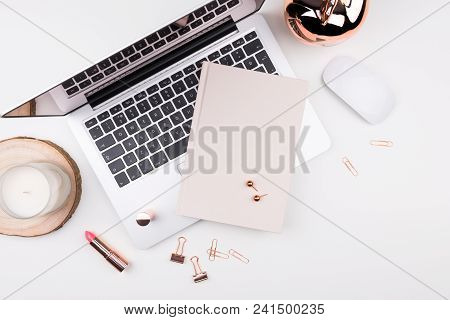 Feminine Flat Lay, Top View Workspace With Laptop, Candle, Notebook, Makeup And Accessories On White