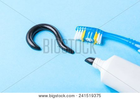 Black Toothpaste From Charcoal For White Teeth. Tooth-paste In The Form Of  Question Mark, Tube And 