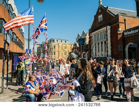 Windsor, United Kingdom - May 19 2018: Cinematic Man Sell Uk And Usa Flags As Well-wishers Move Alon