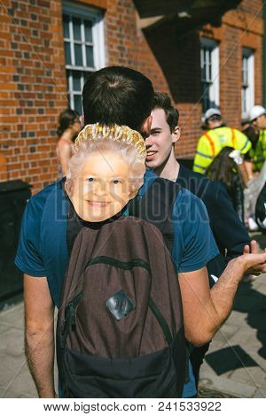 Windsor, Berkshire, United Kingdom - May 19, 2018: Man With Masks Of Queen Elizabeth Ii Heading Roya