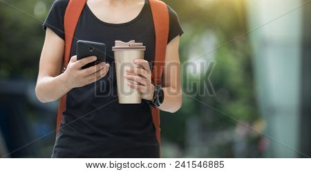 Woman Use Mobile Phone Walking With Coffee Themo Cup In Hand