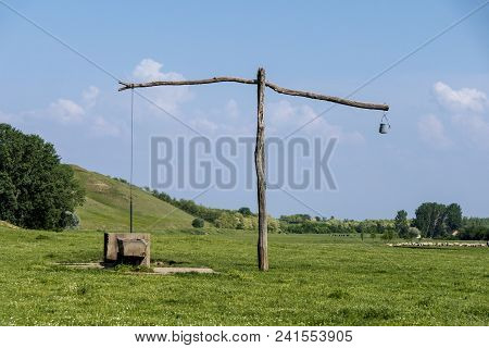 Old Serbian Sweep Well And Shadoof On The Green Meadow