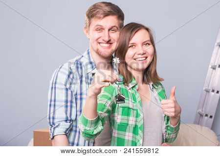 Beautiful Family With Boxes And Holding Flat Keys