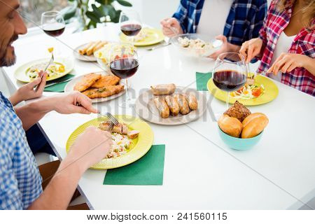 Top View Cropped Portrait Of Festive Relatives Imposing Food In Plates, Sitting In House, Apartment,