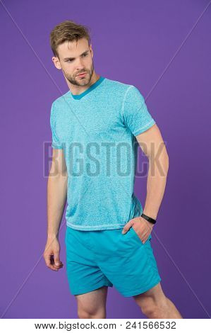 Sportsman In Tshirt And Shorts On Violet Background. Man In Blue Casual Clothes. Macho In Active Wea
