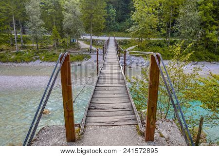 Swingbridge Over Soca River In Triglav National Park, Slovenia, Europe.