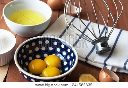 Separation The Yolk Of Egg In Little Bowl And And Preparation For The Whisking Of Egg Whites And Yol