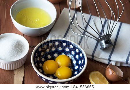 Separation The Yolk Of Egg In Little Bowl And And Preparation For The Whisking Of Egg Whites And Yol