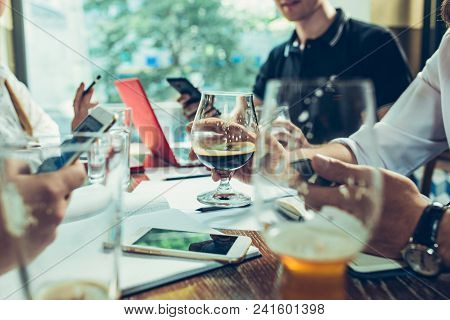 Young Cheerful People Smile And Gesture While Relaxing In Pub. Team Job. Photo Young And Mature Busi