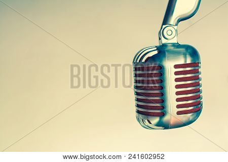 Silver Vintage Microphone With Red Membrane ?lose Up On A Grey Vintage Background