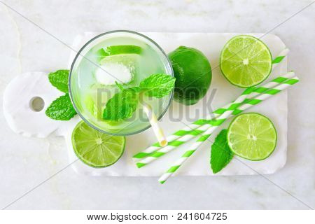 Summer Limeade In A Glass. Top View On A Marble Server Against A Bright Background.