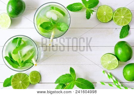 Sweet Summer Limeade. Top View Frame With Limes And Mint On A White Wood Background.