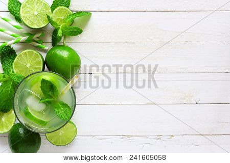 Sweet Summer Limeade. Top View Side Border With Copy Space On A Rustic White Wood Background.