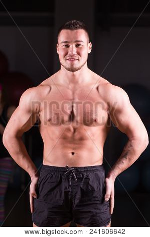 Mixed Race Man Is Working Out On Butterfly Machine In Gym.