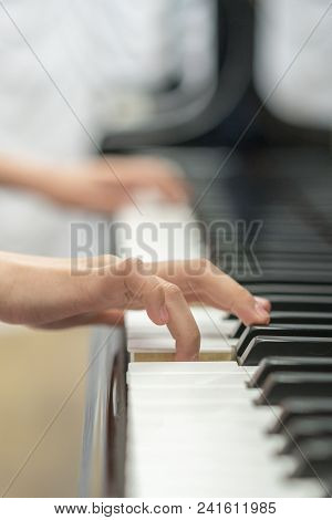 Children's Hands Are Playing The Piano. Child's Hand On Piano Keys