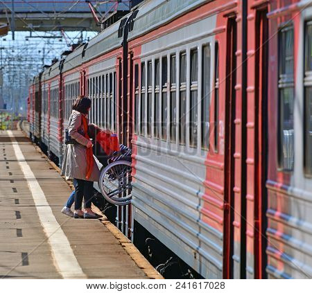Skhodnya, Russia - May 09. 2018. A Man In A Wheelchair Enters A Train.