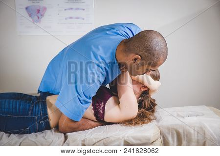Woman Having Chiropractic Back Adjustment. Osteopathy, Alternative Medicine, Pain Relief Concept. Ph