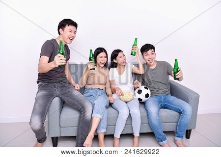 Concept Of Cheering. Asian Teenagers Watching Football On Television. People Are Cheering And Winnin