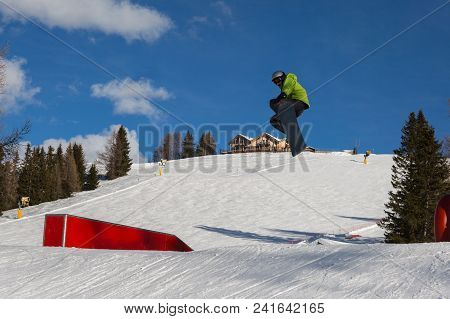 Bolzano, Italy - February 2018: Snowboarder In Action: Jumping In The Mountain Snowpark.