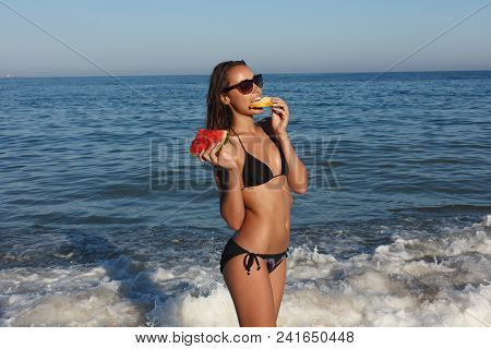 Summer Vacation - Young Girl Eating Fresh Watermelon On Sandy Beach