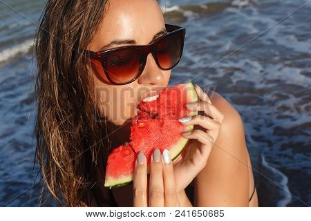 Summer Vacation - Young Girl Eating Fresh Watermelon On Sandy Beach