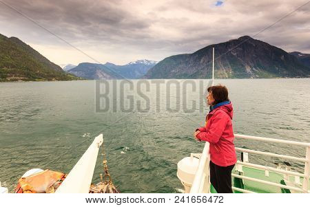 Travel Holiday And Tourism. Tourist Woman On Cruise Ship Boat Enjoying Fjord Norddalsfjorden View, N