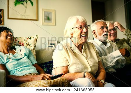 Senior people watching a funny televison show