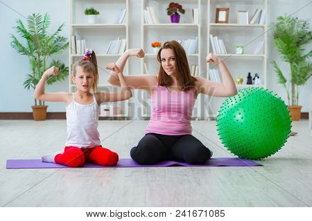 Girl and mother exercising at home