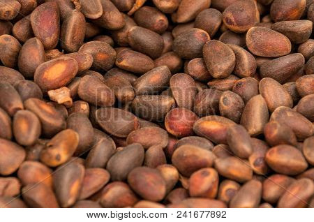 Uncleaned Pine Nuts In A Brown Shell Lie Mixed Up Closeup