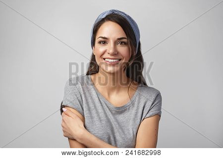 Portrait Of Happy Beautiful Young Housewife Wearing Casual Gray T-shirt And Head Band Smile Joyfully