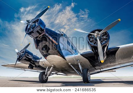Historical Aircraft On An Airfield Under A Blue Sky