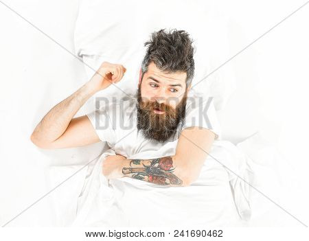 Man With Surprised Face Wake Up, Lay On Bed, White Sheets, Top View. Hipster With Beard, Mustache An