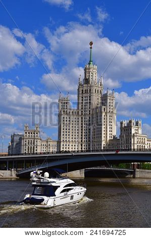 Moscow, Russia - May 12. 2018 Motor Yacht Princess 58 And Skyscraper On A Kotelnicheskaya Embankment