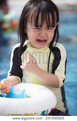 Asian Little Chinese Girl Crying In Swimming Pool Outdoor