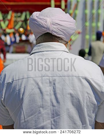 Sikh Ethnic Man With A Pink Turban During A Religious Ceremony