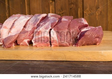 Raw Fat Cuting Pieces Of Pork On Wooden Background. Piece Of Fresh Boneless Pork, Neck Part Or Colla