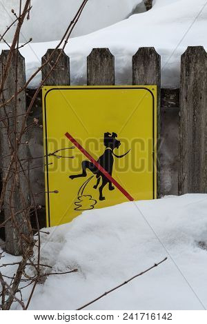 Yellow Signboard: A Signal Prohibiting Dog Excrements Near Fresh Snow.