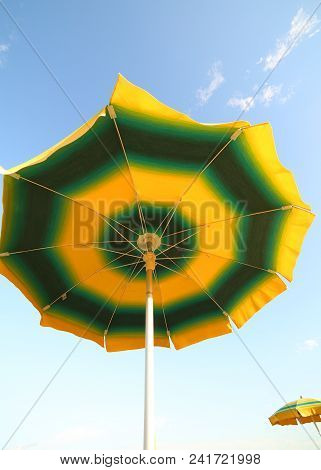 Sun Umbrella And Blue Sky In Summer Bottom View