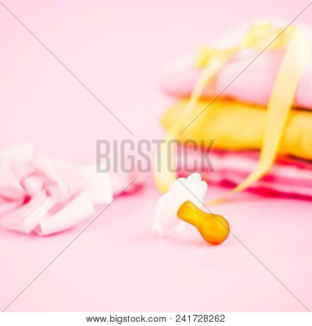 Newborn Stuff, Clothes And Pacifier For Baby Girl On Pink Background