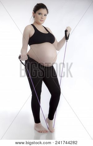 Pregnant Woman Doing Gymnastic Exercises On White Background
