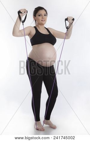 Pregnant Woman Doing Gymnastic Exercises On White Background