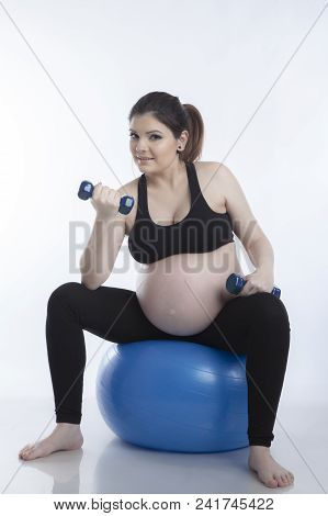 Pregnant Woman Is Doing Exercises With Gymnastic Ball On White Background