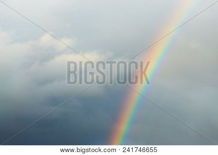 A Bright Rainbow On A Dark Stormy Sky.