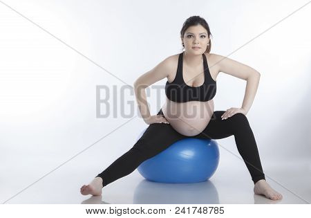 Pregnant Woman Is Doing Exercises With Gymnastic Ball On White Background