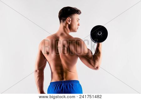 Back Behind View Portrait Of Strong Massive Handsome Muscular Man's Back And Shoulders, He Is Pushin