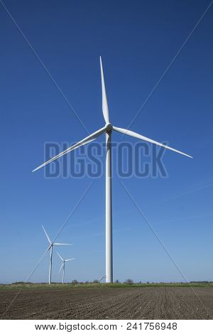 Wind Energy Turbines Field With Blue Sky, Renewable Electric Energy Source, Green Energy Nature Frie