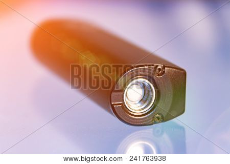 Battery From An Electronic Cigarette On A Glass Table